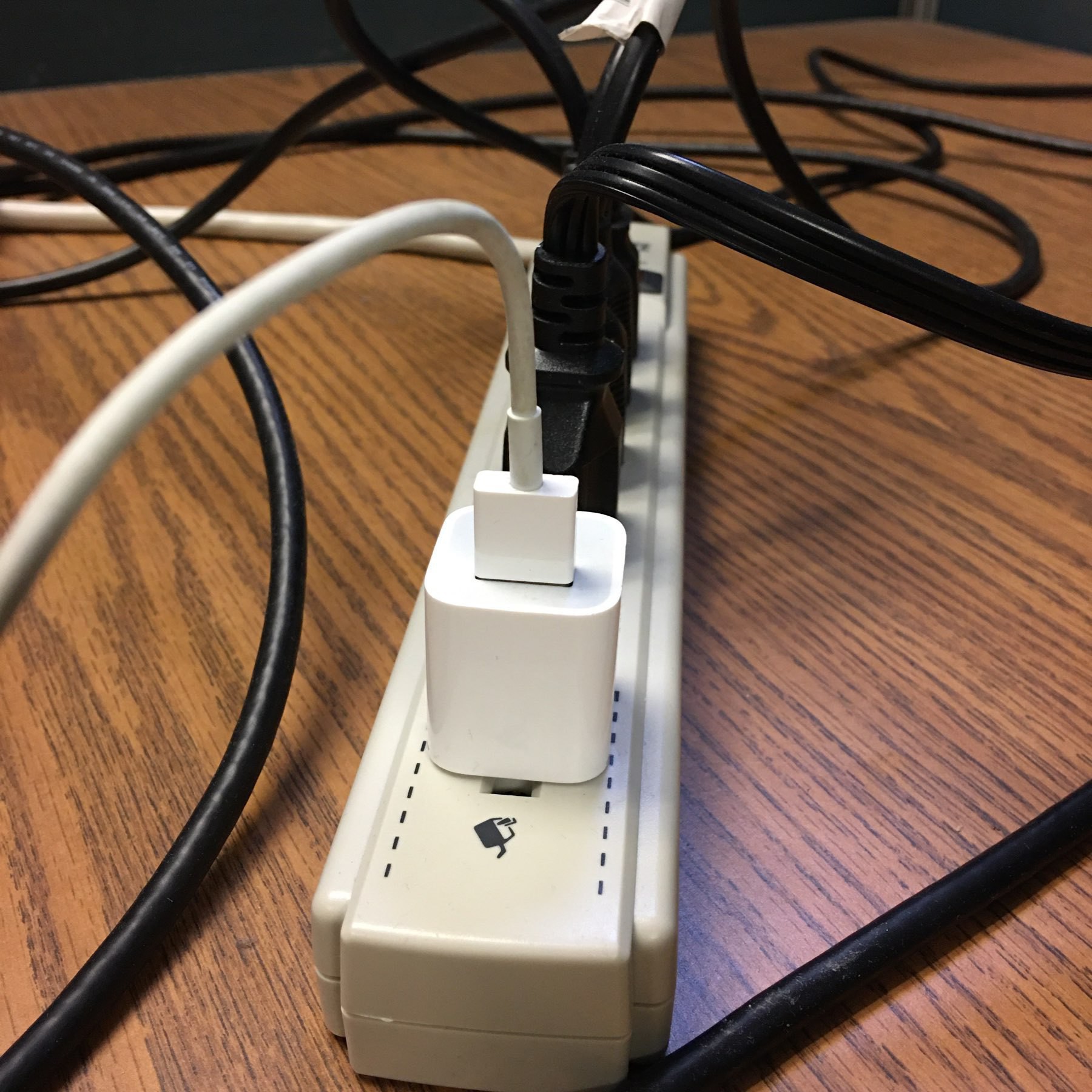 Lightining cable connected to a power brick and extension cord. 