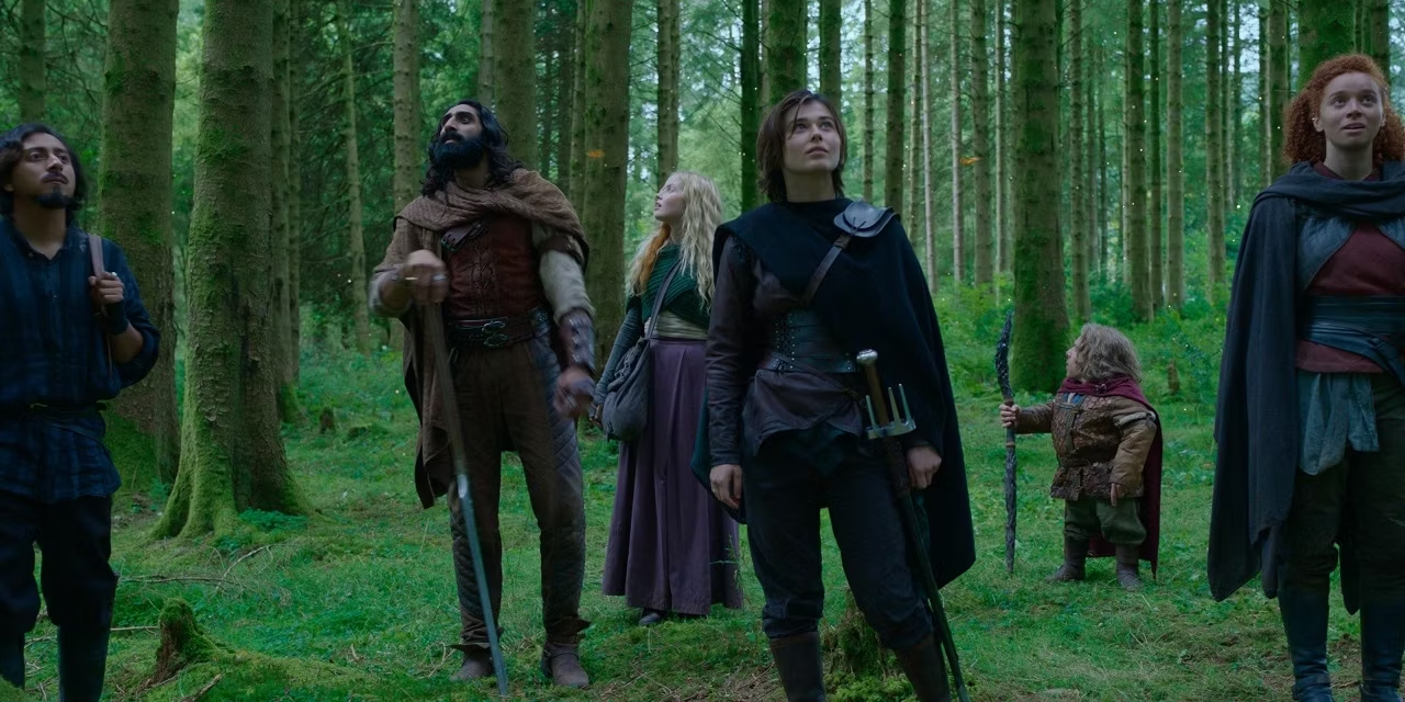 Most of the main characters in the show on an epic forest set.